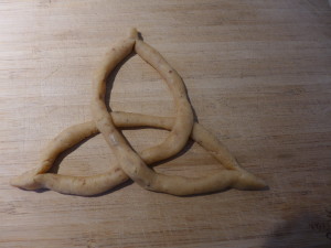 Pinch the ends of the arms to give it a point, and readjust the dough until it looks like this picture.